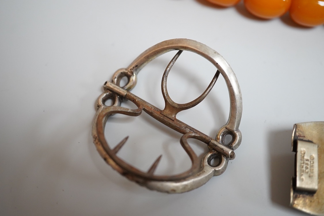 A group of antique and later jewellery inc. cased paste set spray brooch, a Mexican paste set brooch, a paste set shoe buckle and a pressed amber necklace.